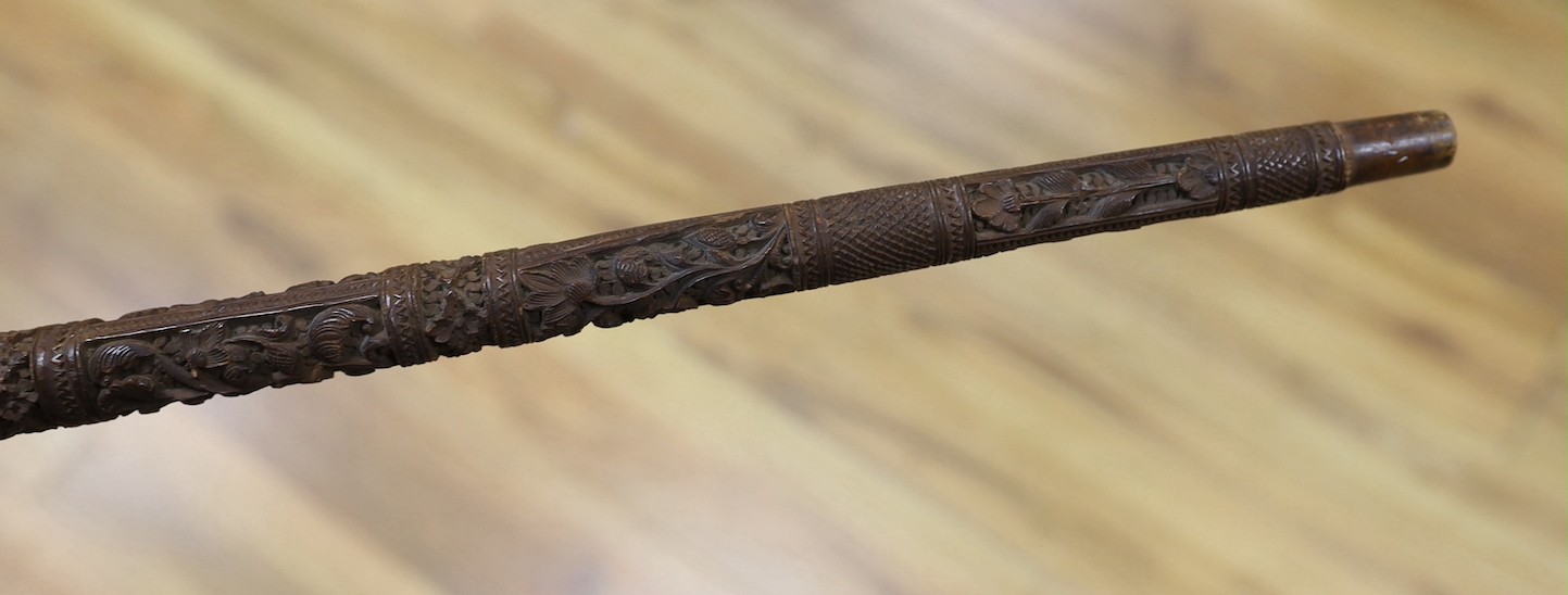 An Asian carved wood walking cane, 7 cm long.